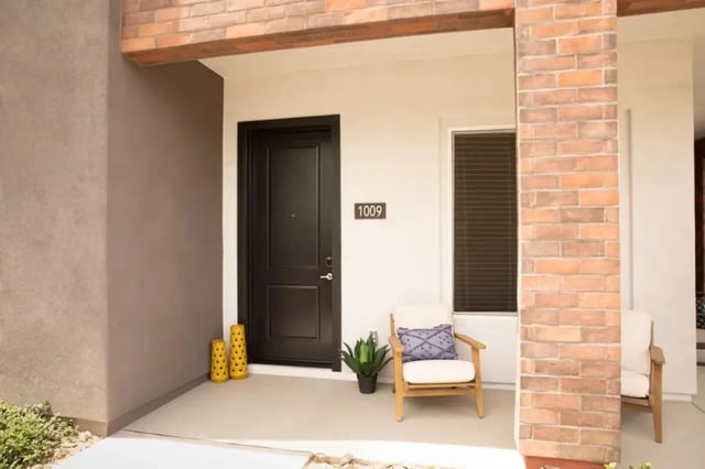 Front door chairs plant and yellow vases exterior at BB Living at Civic Square in Goodyear Student Accommodation