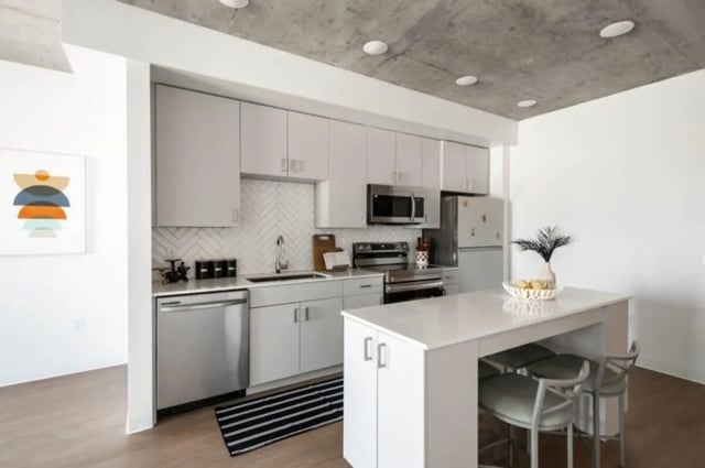 Modern white kitchen with island and stools Kitchen at Ari on Fourth in Tucson Student Accommodation