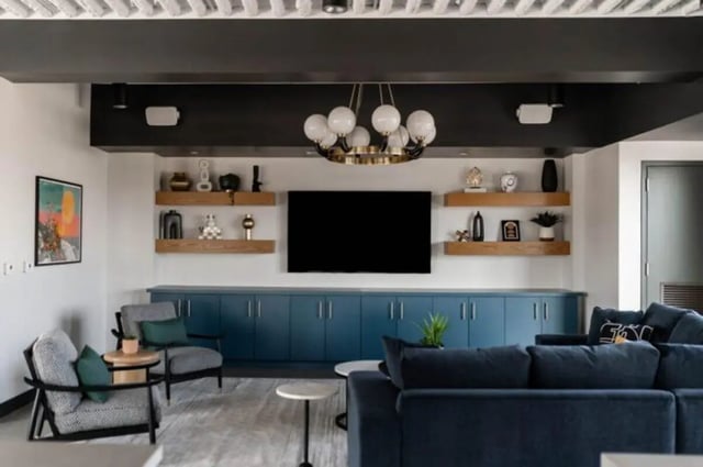 Blue cabinets TV shelves seating living room at Ari on Fourth in Tucson Student Accommodation