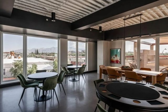 Poker tables dining tables green chairs common area at Ari on Fourth in Tucson Student Accommodation