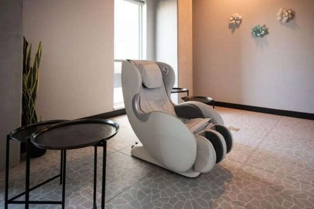 Massage chair with tables and plant common area at Ari on Fourth in Tucson Student Accommodation