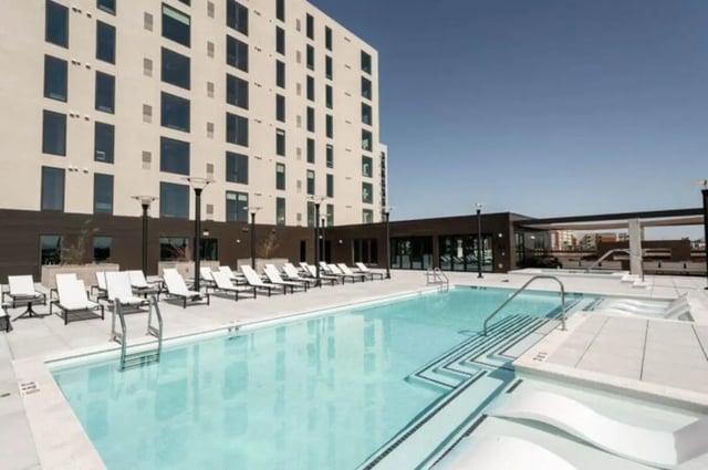 Pool lounge chairs building exterior at Ari on Fourth in Tucson Student Accommodation
