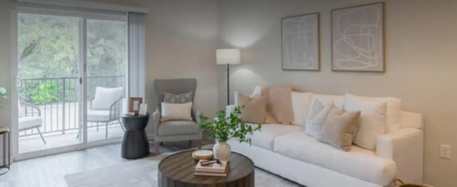 White sofa armchair balcony and art living room at Regency Gardens in Bryan Student Accommodation