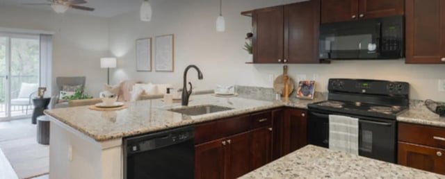Granite countertops dark wood cabinets appliances kitchen at Regency Gardens in Bryan Student Accommodation