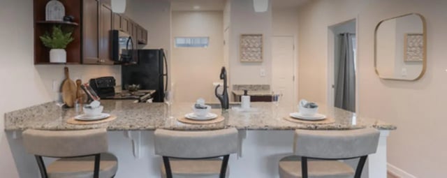 Bar stools at granite counter with plates and decor kitchen at Regency Gardens in Bryan Student Accommodation