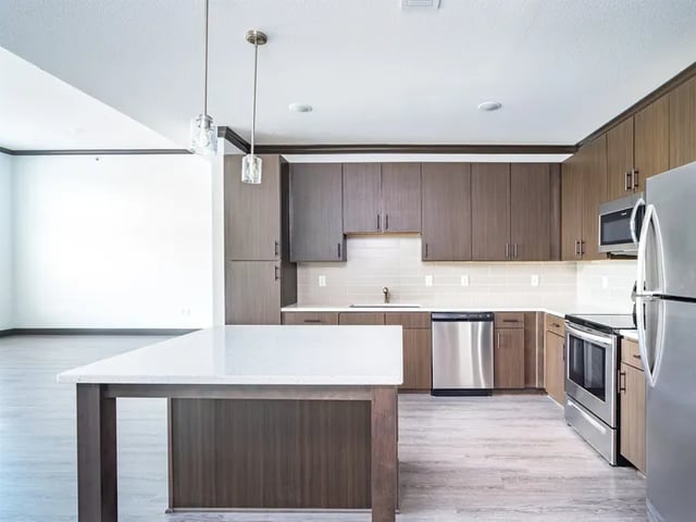 Modern kitchen with island stainless steel appliances kitchen at Parkville Flats in Parkville Student Accommodation