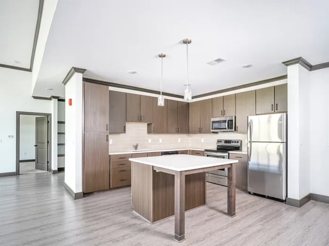 Modern kitchen with island stainless steel appliances kitchen at Parkville Flats in Parkville Student Accommodation