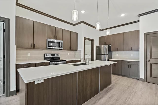 Modern kitchen with stainless steel appliances and island Kitchen at Parkville Flats in Parkville Student Accommodation
