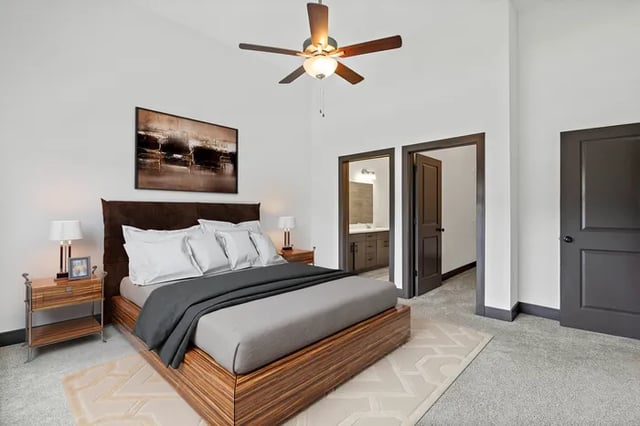 Bed nightstand lamp and fan bedroom at Parkville Flats in Parkville Student Accommodation