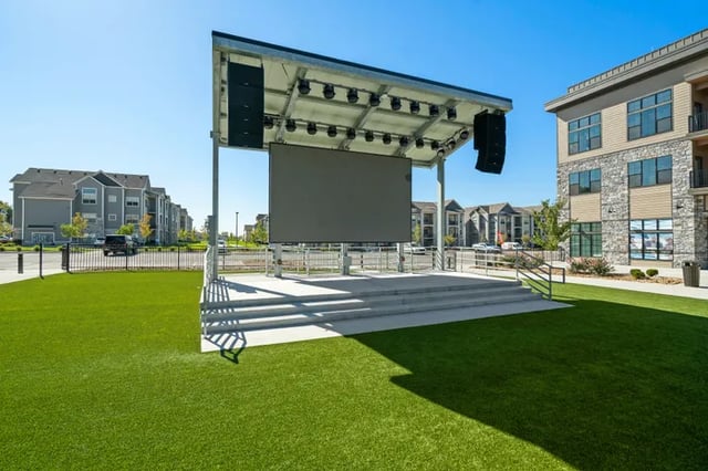 Outdoor stage with screen apartment buildings exterior at Parkville Flats in Parkville Student Accommodation