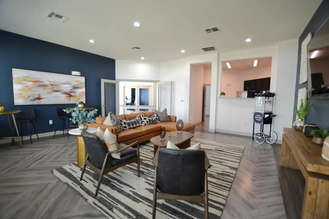 Comfortable sectional sofa two chairs abstract art popcorn cart living room at Riverside Villas in Fort Worth Student Accommodation