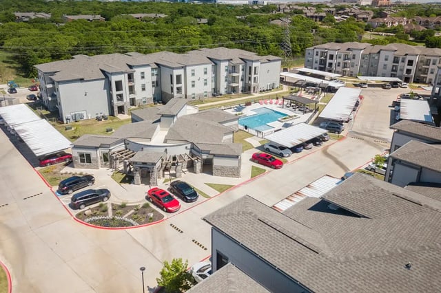 Apartment buildings pool parking cars exterior at Riverside Villas in Fort Worth Student Accommodation