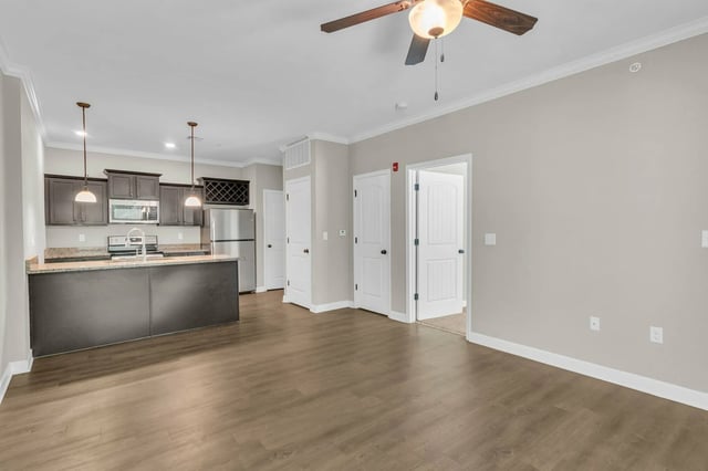 Kitchen with island sink and stainless steel appliances living room at Woodhaven Apartment Living in Kansas City Student Accommodation