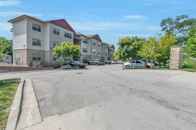 Apartment buildings with cars in parking lot exterior at Woodhaven Apartment Living in Kansas City Student Accommodation
