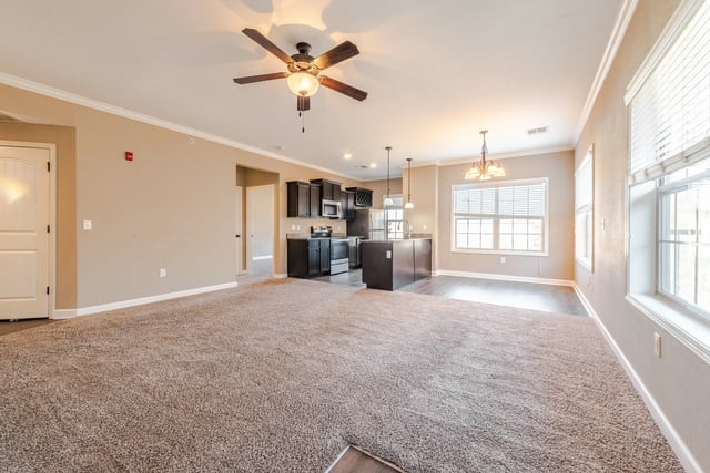 Kitchen appliances island chairs dining area living room at Woodhaven Apartment Living in Kansas City Student Accommodation