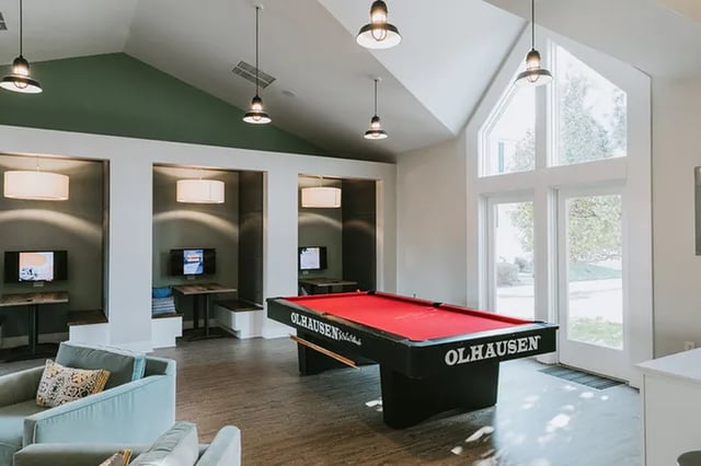 Pool table video games and seating playing area at Canvas Townhomes in Allendale Student Accommodation