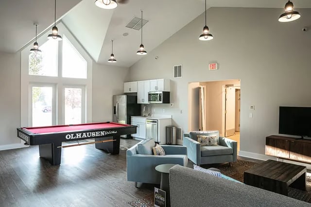 Pool table kitchen living room with armchairs and TV lounge at Canvas Townhomes in Allendale Student Accommodation