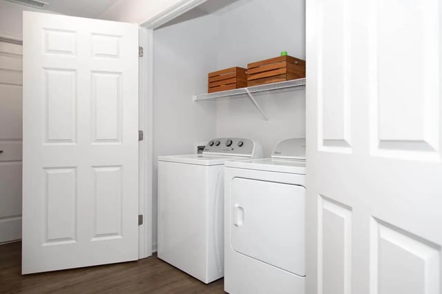Washer dryer stacked with wooden crates Laundry room at Locale Student Housing in Allendale Student Accommodation
