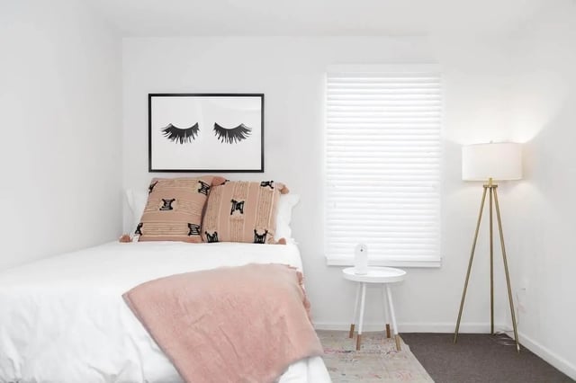 Bed with eyelash art pillows and throw bedroom at Locale Student Housing in Allendale Student Accommodation