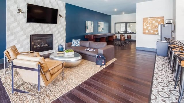Sofa fireplace chairs entertainment table stools living room at Locale Student Housing in Allendale Student Accommodation