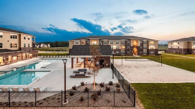 Apartment buildings pool and volleyball court exterior at Locale Student Housing in Allendale Student Accommodation