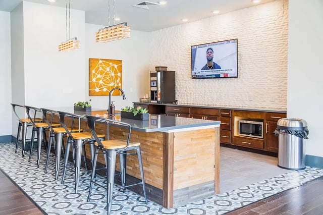 Bar with stools coffee maker microwave trash bin kitchen at Locale Student Housing in Allendale Student Accommodation