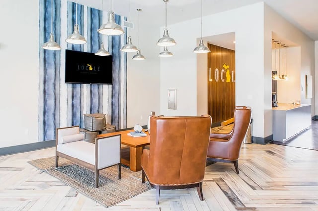 Lounge seating with brown leather chairs and bench lounge area at Locale Student Housing in Allendale Student Accommodation