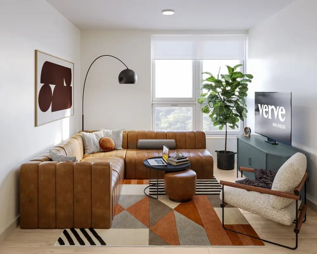 Leather sectional sofa, chair, TV, artwork living room at VERVE Ann Arbor in Ann Arbor Student Accommodation