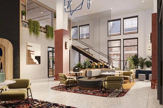 Lounge area with chairs couches and staircase common area at VERVE Ann Arbor in Ann Arbor Student Accommodation