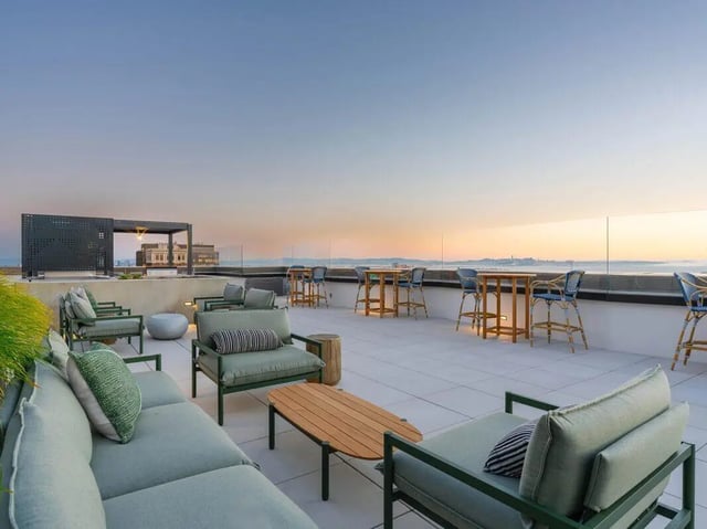Sofa chairs tables and bar stools patio area at Ace Berkeley in Berkeley Student Accommodation