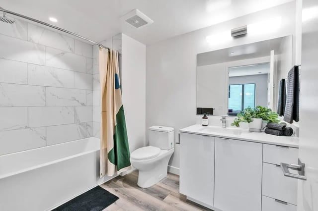 modern bathroom with white vanity toilet shower and tub at Ace Berkeley in Berkeley Student Accommodation