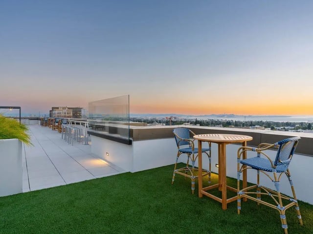 Rooftop balcony with table chairs and city view exterior at Ace Berkeley in Berkeley Student Accommodation