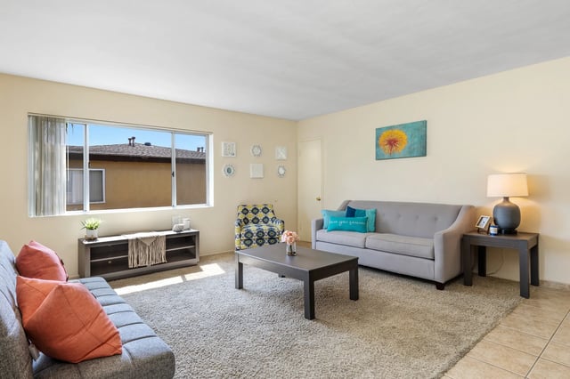 Sofas coffee table armchair living room at College Campanile in San Diego Student Accommodation