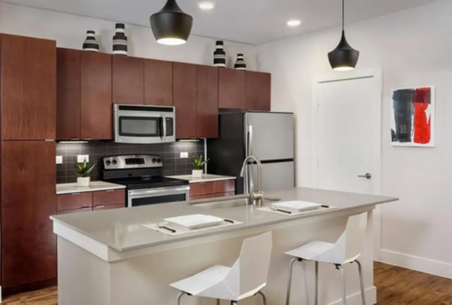 Modern kitchen with island and stainless steel appliances kitchen at The Flats at Big Tex in San Antonio Student Accommodation