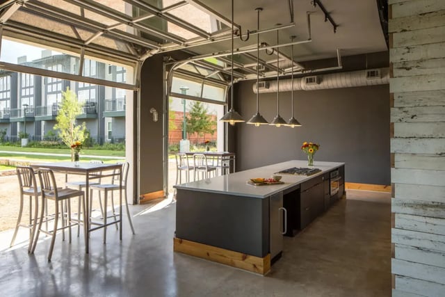 Kitchen island with stools dining table kitchen living room at The Flats at Big Tex in San Antonio Student Accommodation