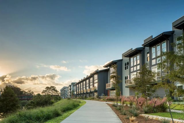 Modern apartments with balconies and pathways exterior at The Flats at Big Tex in San Antonio Student Accommodation