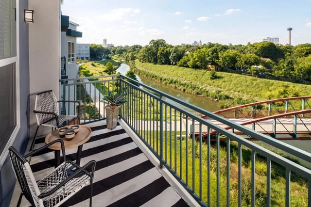 Two chairs table plant balcony view exterior at The Flats at Big Tex in San Antonio Student Accommodation