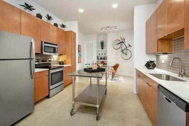 Stainless steel island cabinets refrigerator oven kitchen exterior at The Flats at Big Tex in San Antonio Student Accommodation
