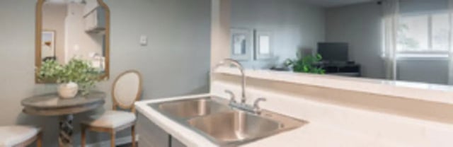 Sink table chairs mirror living room kitchen at The Grand 1501 in College Station Student Accommodation