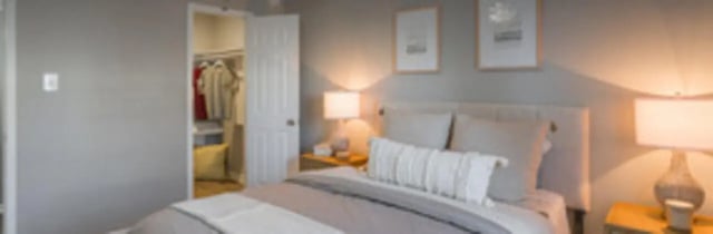 Bed with closet lamps and pictures bedroom at The Grand 1501 in College Station Student Accommodation
