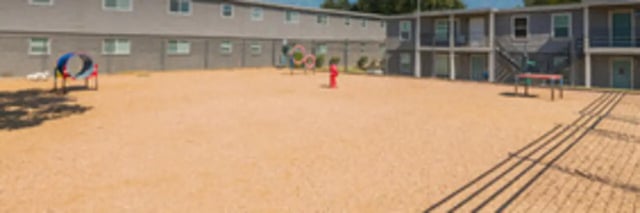 Dog agility equipment on sand area exterior at The Grand 1501 in College Station Student Accommodation