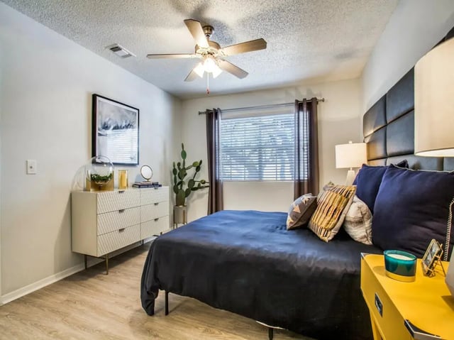 Bed dresser art cactus and ceiling fan bedroom at The Joseph at Huebner in San Antonio Student Accommodation