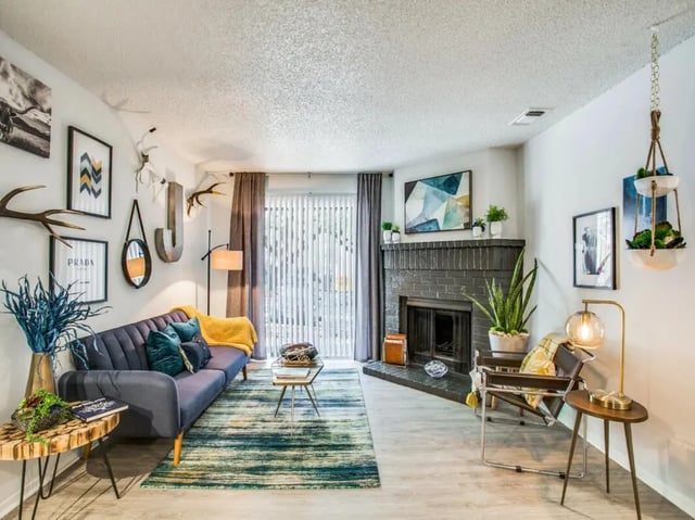 Blue sofa fireplace decor modern living room living room at The Joseph at Huebner in San Antonio Student Accommodation