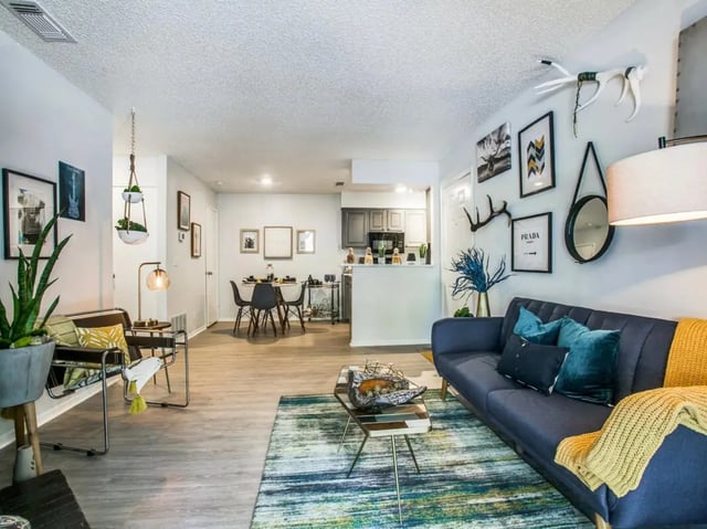 Modern apartment living room with kitchen and dining area at The Joseph at Huebner in San Antonio Student Accommodation