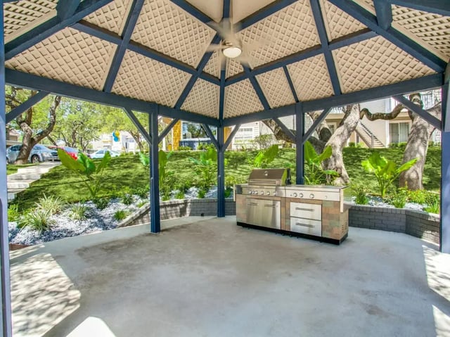 Outdoor kitchen with grill and seating area exterior at The Joseph at Huebner in San Antonio Student Accommodation