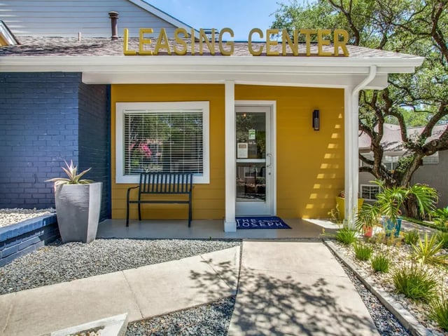 Leasing center exterior with bench and planters exterior at The Joseph at Huebner in San Antonio Student Accommodation