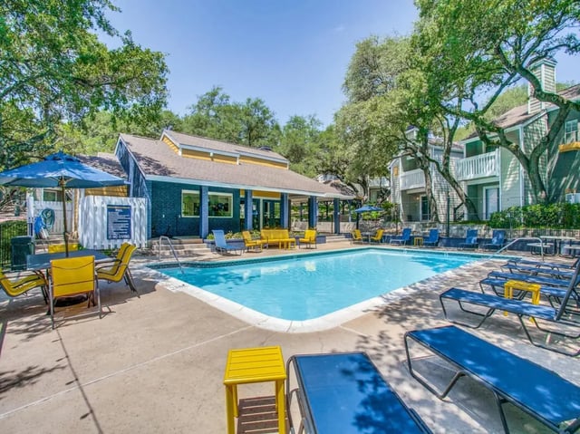 Poolside lounge chairs and tables exterior at The Joseph at Huebner in San Antonio Student Accommodation