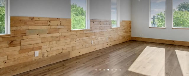 Wooden planked walls light floor and windows Living room at The Lofts at 305 in Bryan Student Accommodation