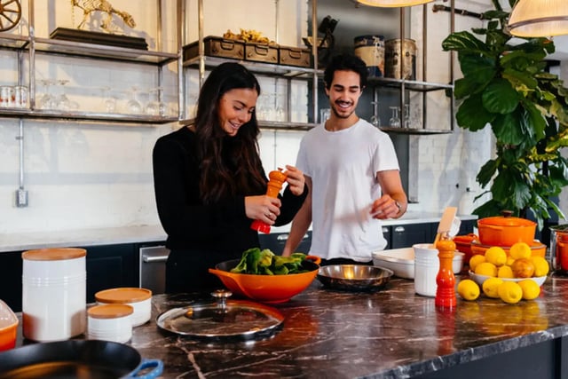 Couple cooking with fresh ingredients in kitchen at The Mercury in Austin Student Accommodation