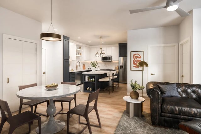 Marble dining table dark chairs modern kitchen living area living room at The Mercury in Austin Student Accommodation